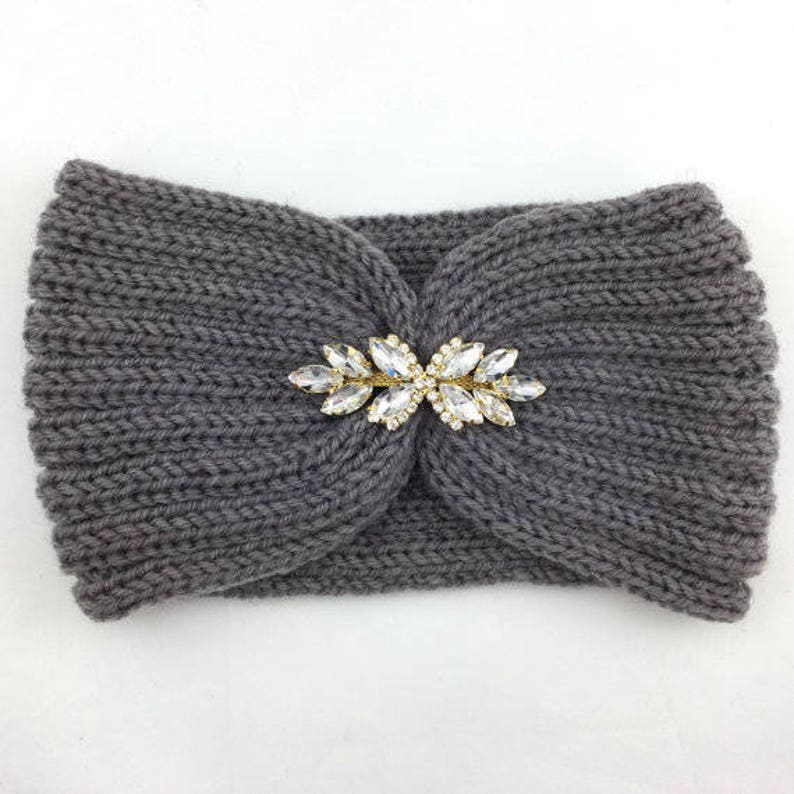 May include: Gray knitted headband with a gold and clear rhinestone embellishment.