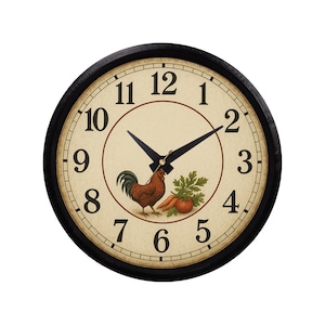 May include: Round wall clock with a black frame and a cream-colored face. The clock face features black numerals, black hands, and a central design of a rooster, carrots, and greenery. The clock measures approximately 12 inches in diameter.