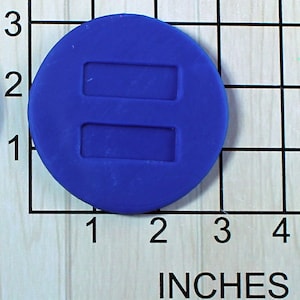 May include: A round, blue silicone mold with two rectangular cutouts. The mold is approximately 2 inches in diameter.