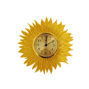 May include: A decorative wall clock shaped like a sunflower. The clock face is gold with black numerals and hands. The sunflower petals are a bright yellow, creating a cheerful and eye-catching design. The clock is a quartz movement.