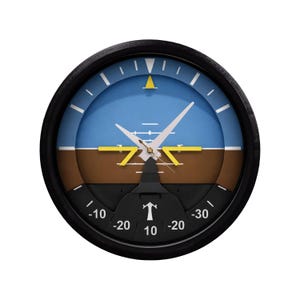 May include: A round wall clock with a black frame, featuring a blue and brown background, and white hands. The clock face resembles an aircraft instrument, with markings and a yellow triangle at the top. The clock has a black base with numbers.