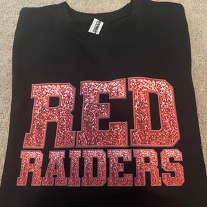 May include: Black t-shirt with a pink glitter design that says "RED RAIDERS".
