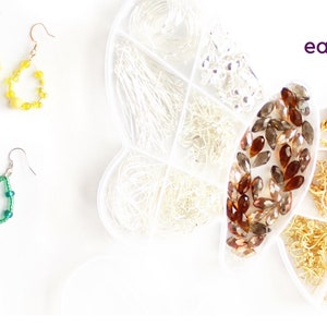 May include: Earrings in yellow and green with silver hooks are displayed alongside jewelry-making supplies. A clear container holds various silver and gold-colored findings. The word "earth" is written in purple.