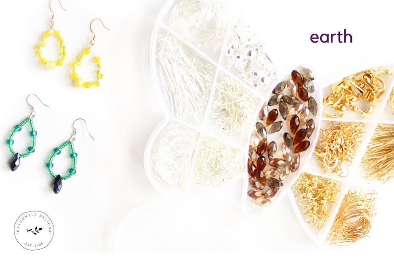 May include: Earrings in yellow and green with silver hooks are displayed alongside jewelry-making supplies. A clear container holds various silver and gold-colored findings. The word "earth" is written in purple.