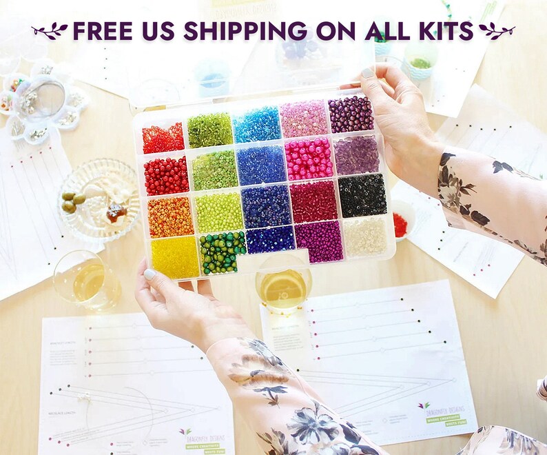 May include: A clear plastic container filled with 16 small compartments, each containing a different color of seed beads. The container is open and the beads are visible. The text "FREE US SHIPPING ON ALL KITS" is visible at the top of the image.