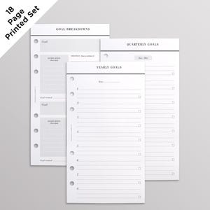 May include: An 18-page printed goal planner set featuring white paper sheets with black text and lines. The pages include sections titled Goal Breakdowns, Quarterly Goals, and Yearly Goals, each with punch holes along the left side for binder insertion.