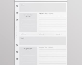 May include: A white planner insert page titled GOALS with two sections for goal setting. Each section includes fields for Goal, Action Steps, Strategy, Goal Created, To Achieve By, and Achieved. The left side features six circular binder holes.