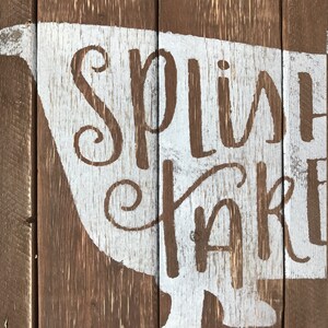 May include: White painted wooden sign with a bathtub silhouette and the words "Splish Splash" in a cursive font.