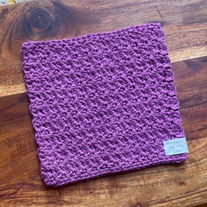 May include: Purple crocheted dishcloth with a white tag that says "Handmade with Love".