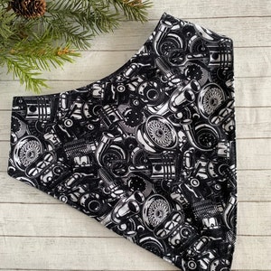 May include: Black and white bandana with a repeating pattern of engine parts. The bandana is triangular in shape and has a white background with black engine parts.
