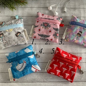 May include: Five small zippered pouches with different medical themed prints. The pouches are made of fabric and have a zipper closure. The pouches are labeled with numbers 1 through 5. The text "ESPECIALLY UNIQUE" is printed on the pouches.