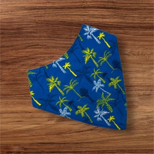 May include: A blue bandana with a white and yellow palm tree pattern.