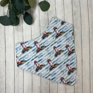 May include: A white bandana with a blue and white striped pattern and a watercolor print of red lighthouses.