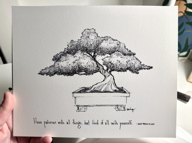 May include: Black and white ink drawing of a bonsai tree in a pot. The quote "Have patience with all things, but first of all with yourself." is written below the tree.