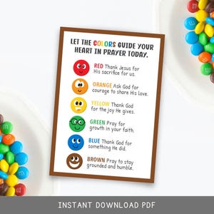 May include: A colorful printable guide with the text "LET THE COLORS GUIDE YOUR HEART IN PRAYER TODAY." The guide features emojis and corresponding prayer prompts for red, orange, yellow, green, blue, and brown. Colorful candies surround the guide.