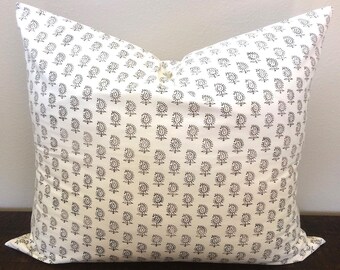 May include: A white pillow with a black paisley pattern. The pillow is made of a soft, comfortable fabric and is perfect for adding a touch of style to any room.