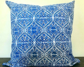 May include: Blue and white patterned throw pillow with a geometric design. The pillow is made of a soft, cotton fabric and has a square shape.