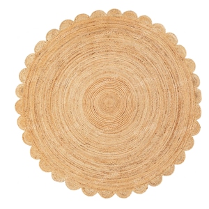 May include: A round, natural jute rug with a scalloped edge. The rug's design features concentric circles radiating from the center. The neutral color and texture of the rug make it suitable for various interior styles.