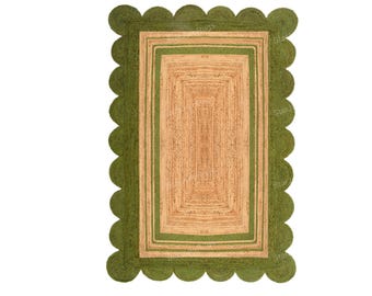 May include: Rectangular jute rug with a scalloped green border and a central rectangular design. The rug features a natural tan color in the center, framed by a green border and a green inner rectangle. This rug is suitable for indoor use.