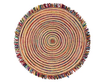 Op de afbeelding: Rond jute vloerkleed met concentrische cirkels in natuurlijk beige, rood, blauw en groen. Het vloerkleed heeft een gefranjerde rand met kleurrijke kwastjes. Dit decoratieve vloerkleed is geschikt voor woonkamers en slaapkamers.