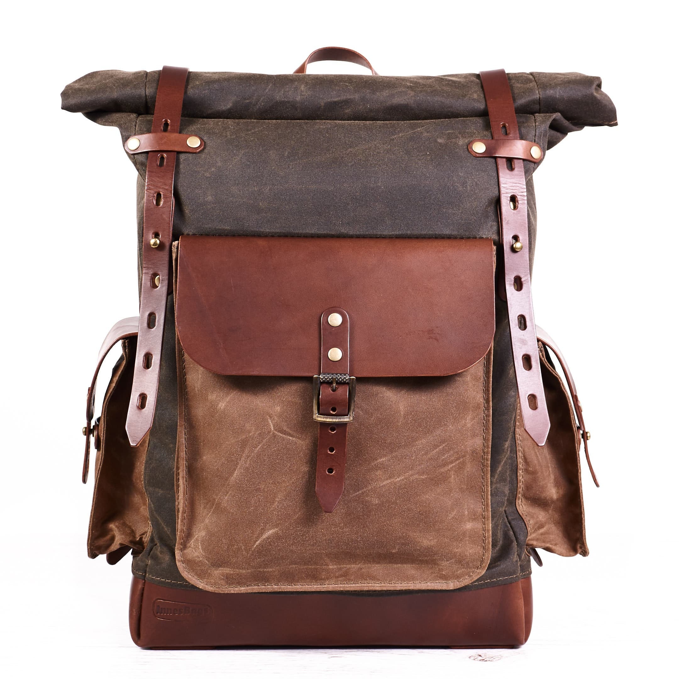 Vintage style waxed canvas rolltop backpack in olive and tan colour.