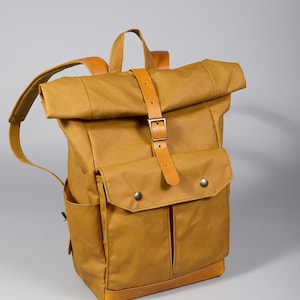 Yellow carry-on backpack with five pockets and padded section for 13" laptop. Personalized Waxed canvas rolltop backpack. Free engraving