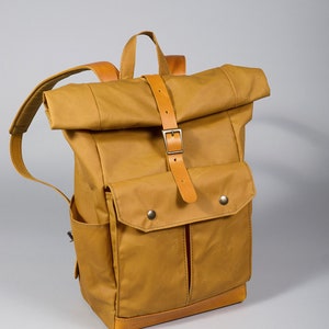 Yellow carry-on backpack with five pockets and padded section for 13" laptop. Personalized Waxed canvas rolltop backpack. Free engraving