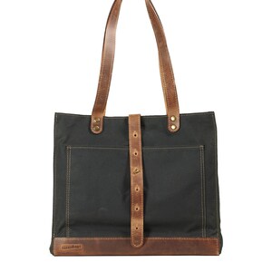 Waxed canvas tote bag in dark green timber. Leather handles, key chain