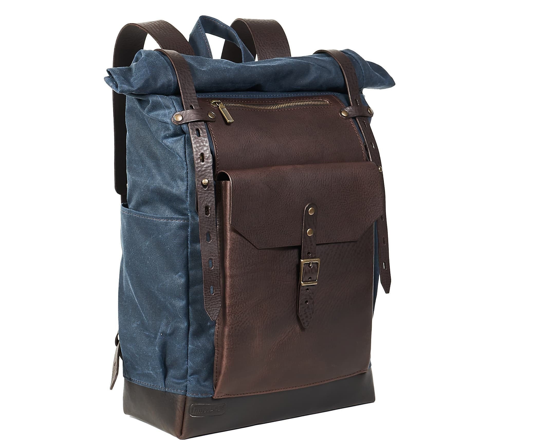 Roll top waxed canvas leather backpack in navy blue and brown.