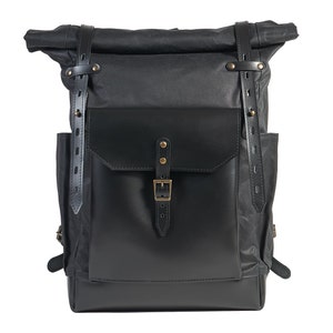 Black waxed canvas leather rucksack with volume front pocket. Waterproof school backpack. Padded laptop section. Customized backpack