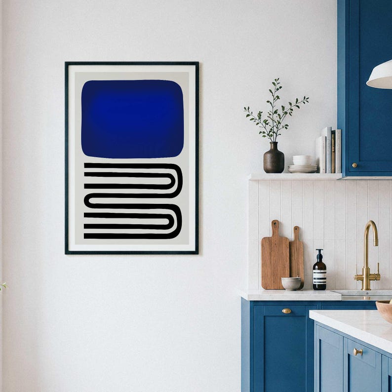 May include: A framed wall art print featuring a large solid blue rectangle positioned above a series of three stacked, black, U-shaped lines that create a continuous, repeating wave pattern on a light beige background within a black frame.