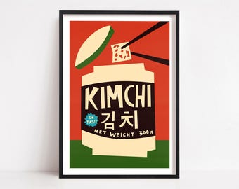 May include: A framed art print featuring a stylized graphic of a kimchi container against a red and green background. The label reads KIMCHI, Korean characters, SO TASTY, and NET WEIGHT 300g. Black chopsticks hold a piece of kimchi above the open jar.