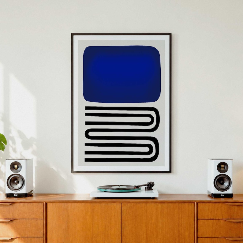 May include: A framed wall art print featuring a large solid dark blue rectangle positioned above a series of black horizontal lines that curve and connect in a continuous, stacked, U-shaped pattern against a light gray background.