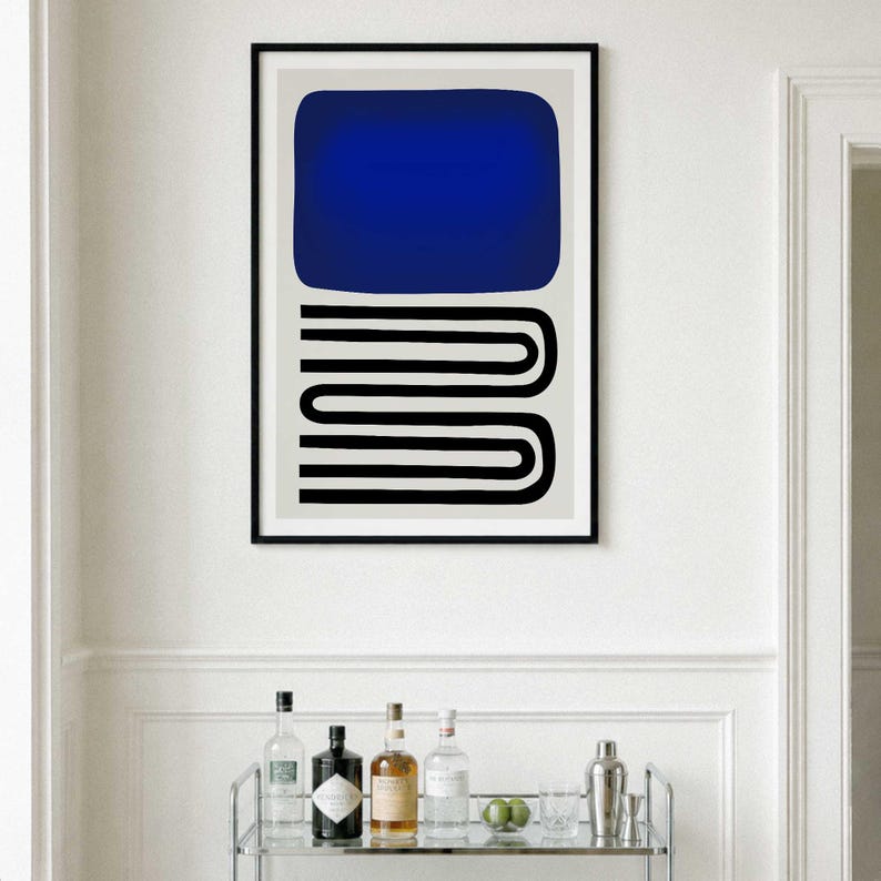 May include: A framed wall art print featuring a large solid blue rectangle positioned above a series of black horizontal lines that curve and connect in a continuous, stacked U-shape pattern, all set against a light gray background.