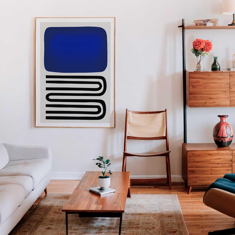 May include: A framed wall art print featuring a large solid blue rectangle positioned above a series of black horizontal lines that curve at the ends to form a continuous, stacked U-shaped pattern, all set against a light gray background.