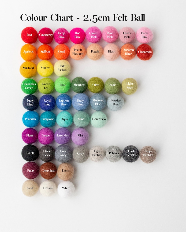 May include: A color chart of 2.5cm felt balls arranged in rows. The chart displays a wide variety of colors including red, pink, orange, yellow, green, blue, purple, grey, brown, and white, each labeled with its specific color name below the ball.