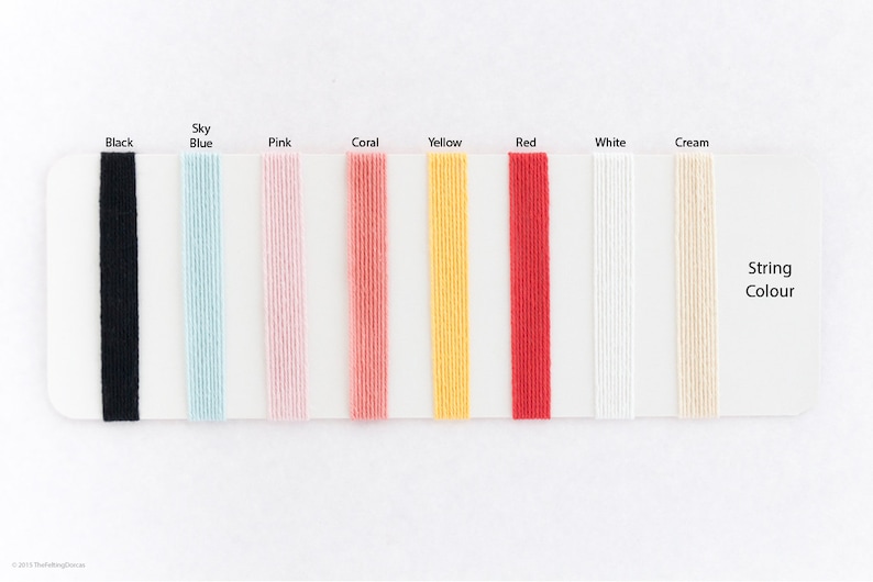 May include: A color chart showing different string colors: black, sky blue, pink, coral, yellow, red, white, and cream. The text "String Colour" is printed on the chart.