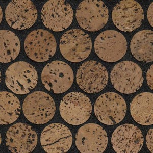 May include: Close-up of a pattern of circular cork pieces with dark spots, arranged in a grid against a dark background. The cork circles have a natural, light brown color, creating a textured, organic design.