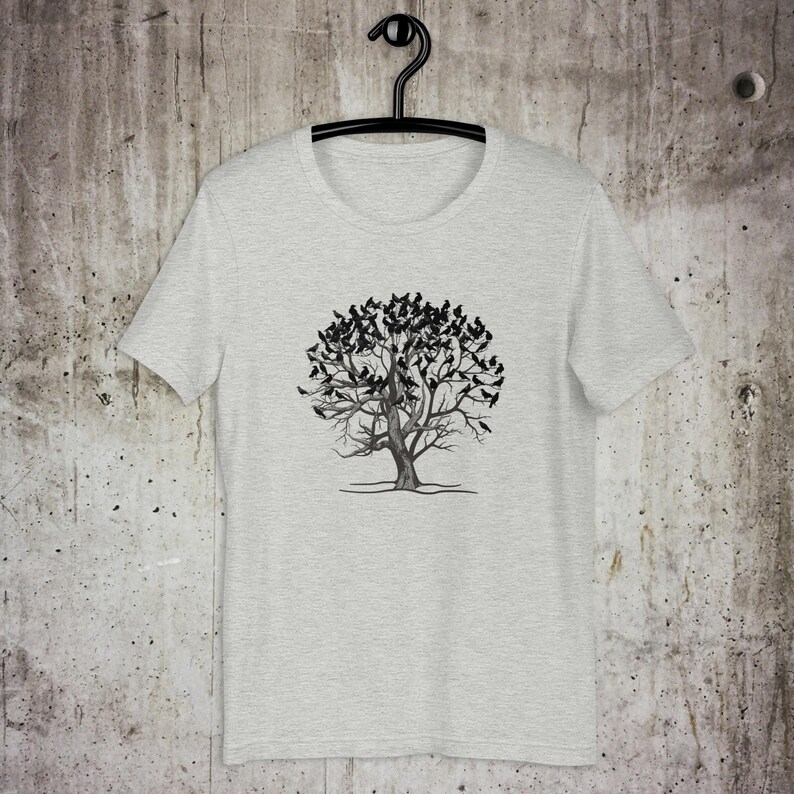 May include: A heather gray t-shirt with a black and white graphic of a tree with birds on the branches.