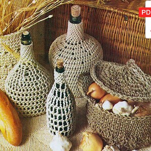 May include: Crocheted covers for bottles and a basket with onions and garlic. The covers are made in a white yarn and the basket is made in a brown yarn.