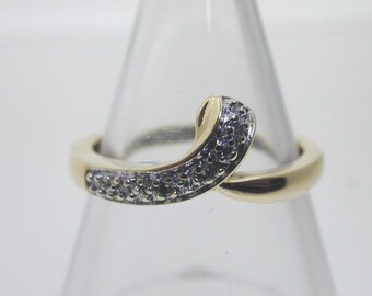 9 carat gold and diamond ribbon crossover ring 0.03 cts size L 1.9 grams