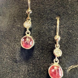 May include: A set of three ceramic mugs with a speckled, matte finish. Each mug is a different colour: light blue, cream, and grey. The mugs have a simple, modern design and a comfortable handle. Ideal for coffee or tea.