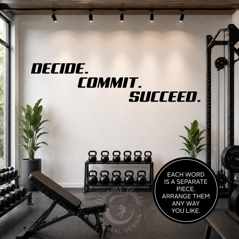 以下が含まれることがあります： 太字のサンセリフ体で「DECIDE. COMMIT. SUCCEED.」と書かれた黒いウォールステッカー。白い壁の3行に配置されており、その下には12個の黒いケトルベルが置かれた黒い金属製のラックが設置されているジムの風景。