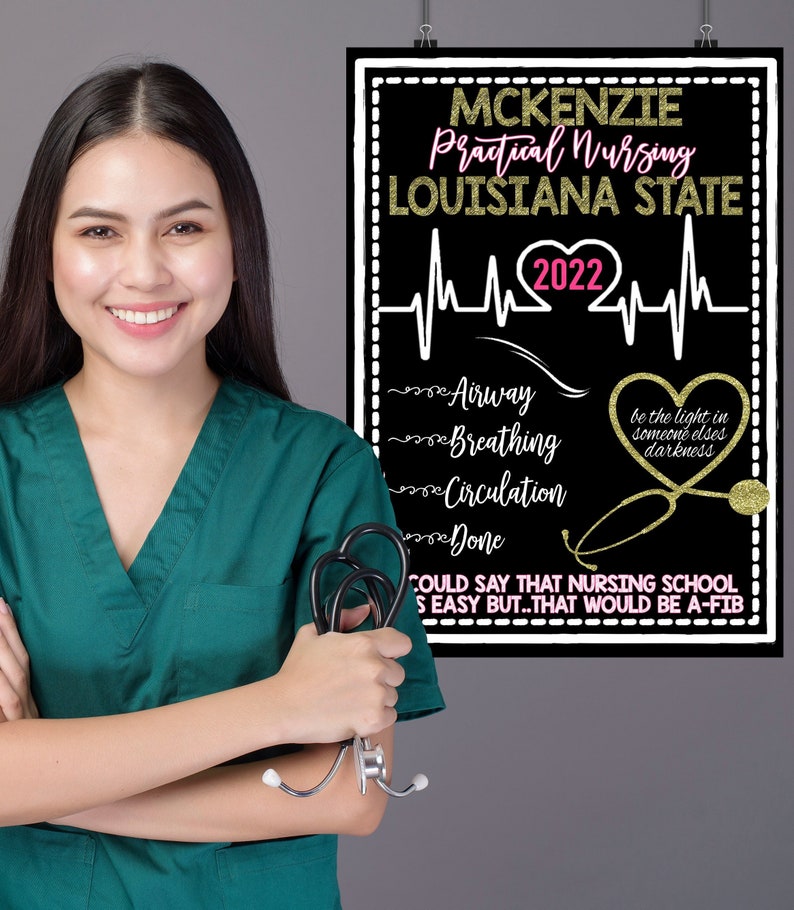 May include: A black chalkboard sign with gold glitter lettering announcing "MCKENZIE Practical Nursing LOUISIANA STATE 2022". The sign includes a heart rate line with a pink heart in the middle. The sign also includes a list of nursing school terms: "Airway", "Breathing", "Circulation", and "Done". A gold glitter stethoscope is pictured on the sign with the text "be the light in someone else's darkness". The sign also includes the text "COULD SAY THAT NURSING SCHOOL IS EASY BUT...THAT WOULD BE A-FIB".