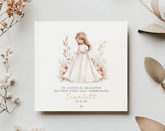 May include: A square greeting card with a watercolor illustration of a girl in a white dress, surrounded by flowers. The text reads, "TO A SPECIAL DAUGHTER ON YOUR FIRST HOLY COMMUNION" with the name "Scarlett" and the date "27.5.25".
