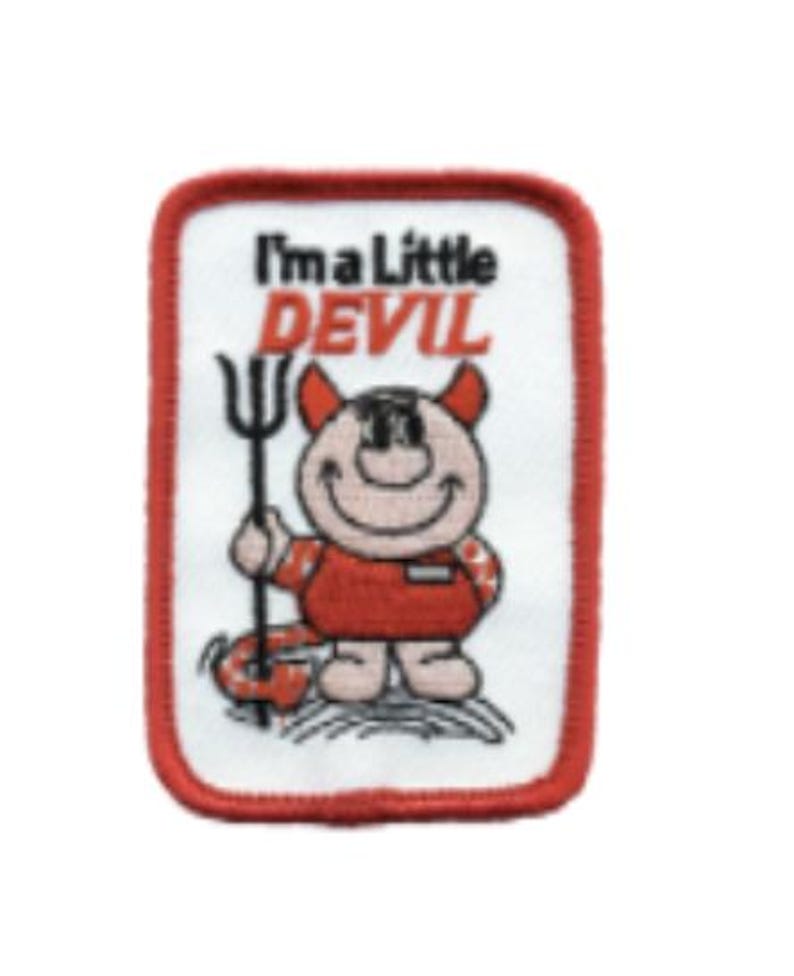 May include: A rectangular embroidered patch with a white background and a red border. It features a cartoon character with horns holding a black pitchfork. The text reads I'm a Little DEVIL in black and red lettering above the character figure.