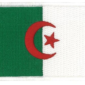 May include: A rectangular embroidered patch featuring the flag of Algeria. The design is vertically divided into a green left half and a white right half, with a red crescent and a red five-pointed star centered over the vertical dividing line.