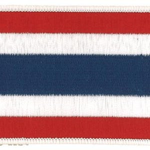 May include: A rectangular embroidered patch featuring the horizontal striped design of the Thai flag. The patch displays five horizontal bands in the order of red, white, blue, white, and red, with a white stitched border surrounding the entire edge.