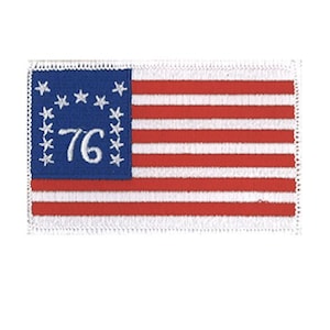 May include: A rectangular embroidered patch featuring the Bennington flag design. It has a blue canton with thirteen white stars arranged in an arch over the white numerals 76, and thirteen alternating horizontal red and white stripes.