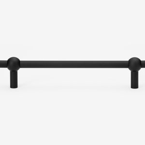 May include: Black cabinet hardware pull with rounded ends. The pull is approximately 5 inches long.